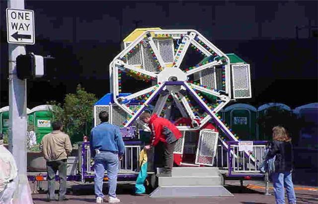 Festival equipment rental with a small Ferris wheel setup at a Houston event.